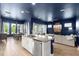 Open concept kitchen and living room with granite countertops, stainless appliances, and hardwood floors at 6212 W Fallsgrove Ln, Port Orange, FL 32128