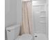 Bathroom with a toilet, shower with curtain, and simple white fixtures at 632 Tarragona Way, Daytona Beach, FL 32114