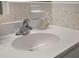Bathroom showcasing a clean white sink with modern fixtures and tile backsplash at 632 Tarragona Way, Daytona Beach, FL 32114