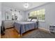 Bright bedroom with hardwood floors, soft lighting, and a large window offering ample natural light at 632 Tarragona Way, Daytona Beach, FL 32114