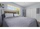 Bedroom features a comfortable bed, large window, and ample closet space for storage solutions at 632 Tarragona Way, Daytona Beach, FL 32114