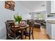 Cozy dining area with a round table, hardwood floors, and comfortable living room in the background at 632 Tarragona Way, Daytona Beach, FL 32114