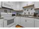 Bright kitchen with white cabinets, hardwood floors and modern appliances at 632 Tarragona Way, Daytona Beach, FL 32114