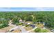 Aerial view of the neighborhood including the homes, trees, and the surrounding landscape on a sunny day at 6509 Lake Lerla Dr, Apopka, FL 32712