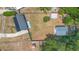 Aerial view of the home and backyard including the metal and wood sheds, grass and surrounding trees at 6509 Lake Lerla Dr, Apopka, FL 32712