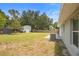 Large backyard featuring a storage shed and wooded views at 6509 Lake Lerla Dr, Apopka, FL 32712