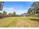 A large backyard with green grass and a wood fence encloses the area, backing up to the home at 6509 Lake Lerla Dr, Apopka, FL 32712