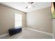 A small bedroom with a bench and a ceiling fan at 6509 Lake Lerla Dr, Apopka, FL 32712