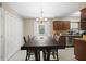 Charming dining area featuring a dark wood table with seating for six and ample lighting at 6509 Lake Lerla Dr, Apopka, FL 32712