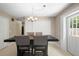 Inviting dining area with tile floors, a modern chandelier, and space for gatherings at 6509 Lake Lerla Dr, Apopka, FL 32712