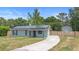 Charming single-story home featuring a well-maintained lawn, solar panels, and a long driveway at 6509 Lake Lerla Dr, Apopka, FL 32712