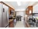 Bright kitchen with stainless steel appliances, tile flooring, and wood cabinetry at 6509 Lake Lerla Dr, Apopka, FL 32712