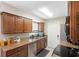Functional kitchen featuring granite countertops, wood cabinets, and stainless steel appliances at 6509 Lake Lerla Dr, Apopka, FL 32712