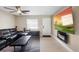 Inviting living room with tile floors, mounted fireplace, and a comfortable leather sofa set at 6509 Lake Lerla Dr, Apopka, FL 32712