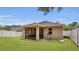 Spacious backyard with green grass, a screened in patio, and privacy fence at 680 Preakness Cir, Deland, FL 32724