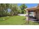 Green backyard features white fencing, a screened in patio, and space for exercise at 680 Preakness Cir, Deland, FL 32724