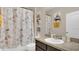 Bathroom featuring a vanity with sink, toilet, and shower with Paris-themed curtain at 680 Preakness Cir, Deland, FL 32724