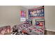 Bedroom with fun race car decor, checkered flags, and cozy twin beds at 680 Preakness Cir, Deland, FL 32724