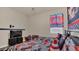 This bedroom showcases fun, car-themed decor and natural light at 680 Preakness Cir, Deland, FL 32724