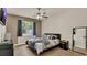 Bedroom features ceiling fan, wallpaper accent wall, hardwood floors, and natural light at 680 Preakness Cir, Deland, FL 32724