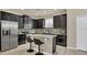 Modern kitchen featuring stainless steel appliances, granite countertops, and dark wood cabinetry at 680 Preakness Cir, Deland, FL 32724
