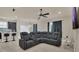 Comfortable living room featuring large sectional sofa, ceiling fan, and neutral color palette at 680 Preakness Cir, Deland, FL 32724