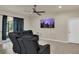 Comfortable living room featuring large screen, ceiling fan, and neutral color palette at 680 Preakness Cir, Deland, FL 32724