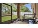 Enclosed porch featuring outdoor views of the fenced yard with a grassy lawn at 680 Preakness Cir, Deland, FL 32724