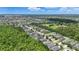 An aerial view shows a neighborhood with green trees, lakes, and single Gathering homes at 6820 Vintage Ln, Port Orange, FL 32128