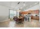 The dining area is situated adjacent to the kitchen, with tile floors, a modern chandelier, and a large window for natural light at 6820 Vintage Ln, Port Orange, FL 32128