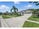 Beautiful home featuring a lush lawn, palm tree, and a gray two-car garage at 6820 Vintage Ln, Port Orange, FL 32128