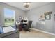 Cozy home office with a wood desk, plush chair, and natural light at 6820 Vintage Ln, Port Orange, FL 32128