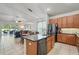 Open kitchen featuring granite countertops, stainless steel appliances, an island with bar seating, and an adjacent dining and living area at 6820 Vintage Ln, Port Orange, FL 32128