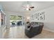 Inviting living room offers a relaxing sectional, a large sliding glass door to the patio, and stylish decor, perfect for entertaining at 6820 Vintage Ln, Port Orange, FL 32128