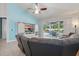 Cozy living room features a comfortable sectional sofa, a custom-built entertainment center, and a sliding glass door to the outdoor pool area at 6820 Vintage Ln, Port Orange, FL 32128