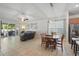 Open-concept living area showcases tile flooring, a comfortable seating area, an adjacent dining space, and sliding glass doors to the patio at 6820 Vintage Ln, Port Orange, FL 32128