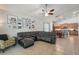 Spacious living room with a large sectional sofa, ceiling fan, and views into the adjacent kitchen and dining area, ideal for gatherings at 6820 Vintage Ln, Port Orange, FL 32128