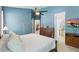 Large bedroom with wooden furniture, a ceiling fan, and TV at 6820 Vintage Ln, Port Orange, FL 32128