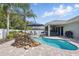 Backyard oasis with a gorgeous pool, rock waterfall, and covered patio at 6820 Vintage Ln, Port Orange, FL 32128