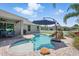 Backyard pool featuring a rock waterfall, umbrella, and brick paver patio creating an inviting outdoor living space at 6820 Vintage Ln, Port Orange, FL 32128