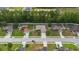 Aerial view of a residential neighborhood showcasing well-maintained homes and tree-lined streets at 703 Elkhorn Fern Ln, Deland, FL 32720