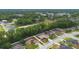 An aerial shot of the neighborhood highlights the lush greenery and proximity to shopping centers at 703 Elkhorn Fern Ln, Deland, FL 32720