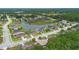 Scenic aerial view of a residential community featuring homes, a pond, and lush greenery at 703 Elkhorn Fern Ln, Deland, FL 32720