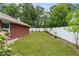 Large backyard with a white vinyl fence and rows of potted plants at 703 Elkhorn Fern Ln, Deland, FL 32720
