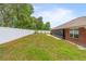 This expansive backyard features a well-maintained lawn, and a white fence creating a private outdoor space at 703 Elkhorn Fern Ln, Deland, FL 32720
