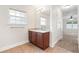 Bathroom featuring a single vanity with drawers and a large mirror with updated lighting at 703 Elkhorn Fern Ln, Deland, FL 32720
