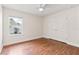 This bedroom features hardwood floors, double closet, bright window, and a ceiling fan at 703 Elkhorn Fern Ln, Deland, FL 32720