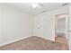 Comfortable bedroom featuring neutral carpet, a ceiling fan, and closet space for storage and relaxation at 703 Elkhorn Fern Ln, Deland, FL 32720