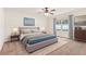 Bedroom featuring neutral walls, carpet, large windows, ceiling fan, and well-coordinated furnishings at 703 Elkhorn Fern Ln, Deland, FL 32720
