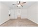 Bright bedroom with neutral carpet, ceiling fan, and hallway access providing a calming, accessible space at 703 Elkhorn Fern Ln, Deland, FL 32720